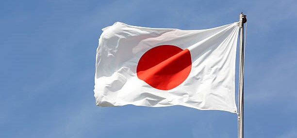 Japanese flag in wind against a blue sky